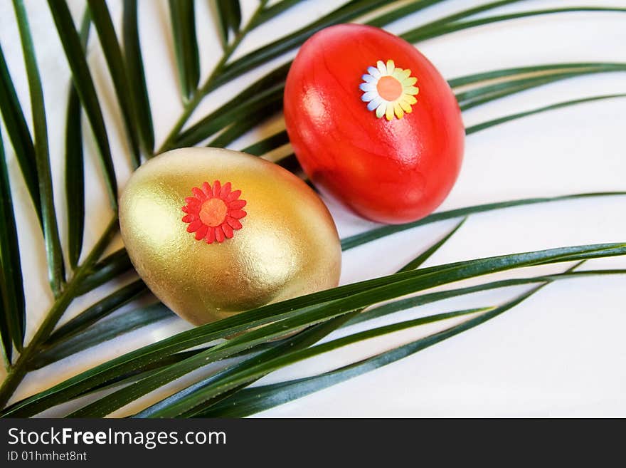 Easter spring celebration with red and golden eggs over decorative leaf. Easter spring celebration with red and golden eggs over decorative leaf.