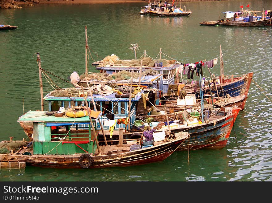 Fishing boats at the floating village in Halong bay in Vietnam