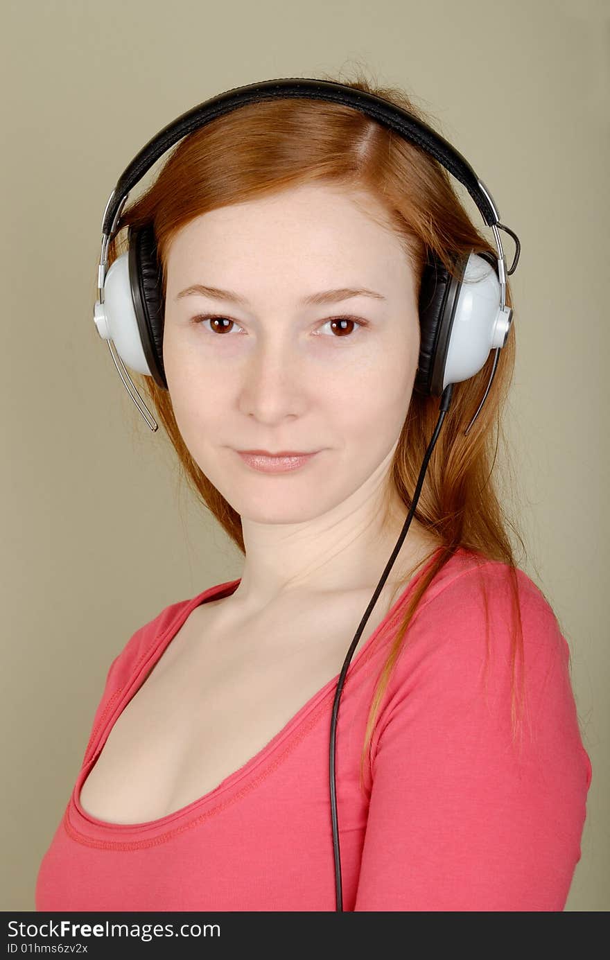 Redhead young woman in headphones