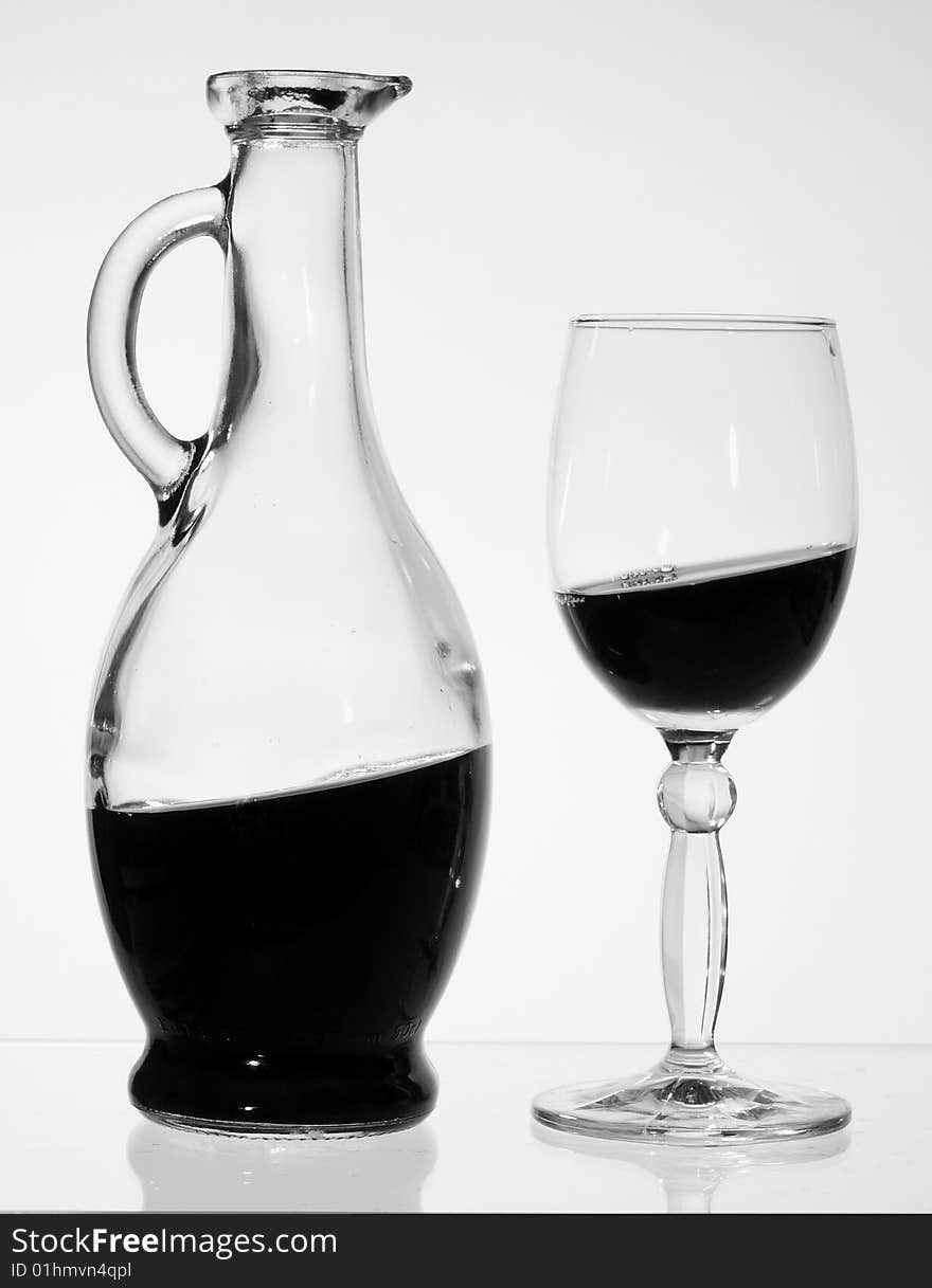 Jug and glass with red wine.