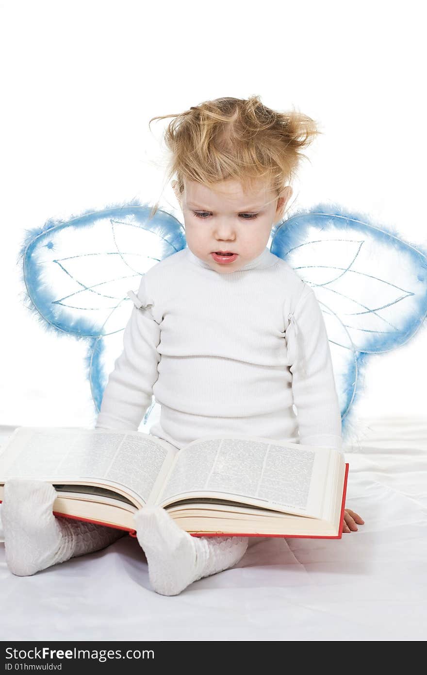 Stock photo: an image of a baby with a book and wings. Stock photo: an image of a baby with a book and wings