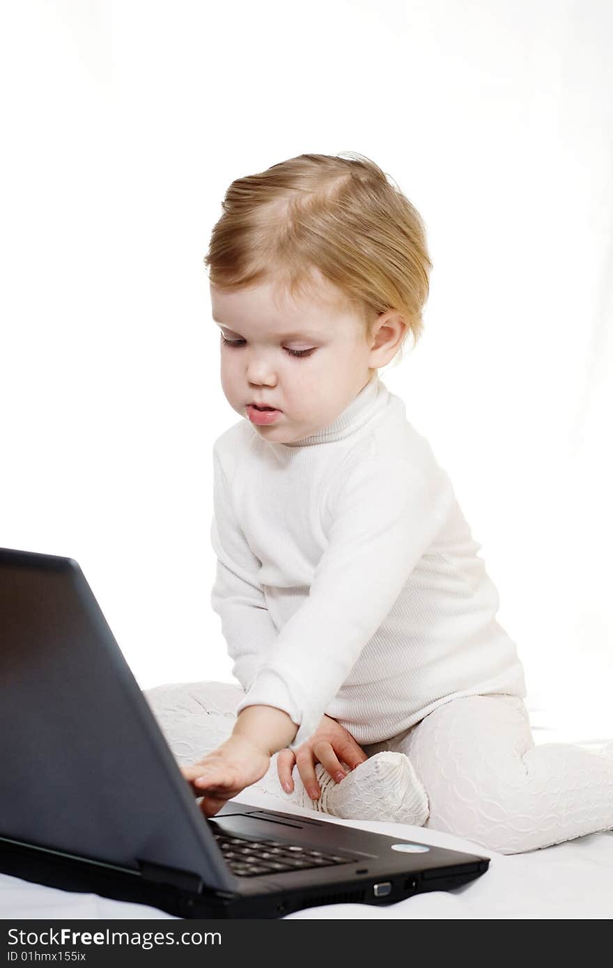 Stock photo: an image of a baby with black laptop