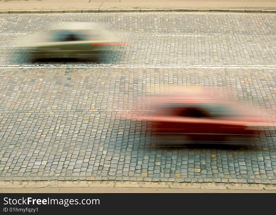 Traffic with motion blur on stone sett paving