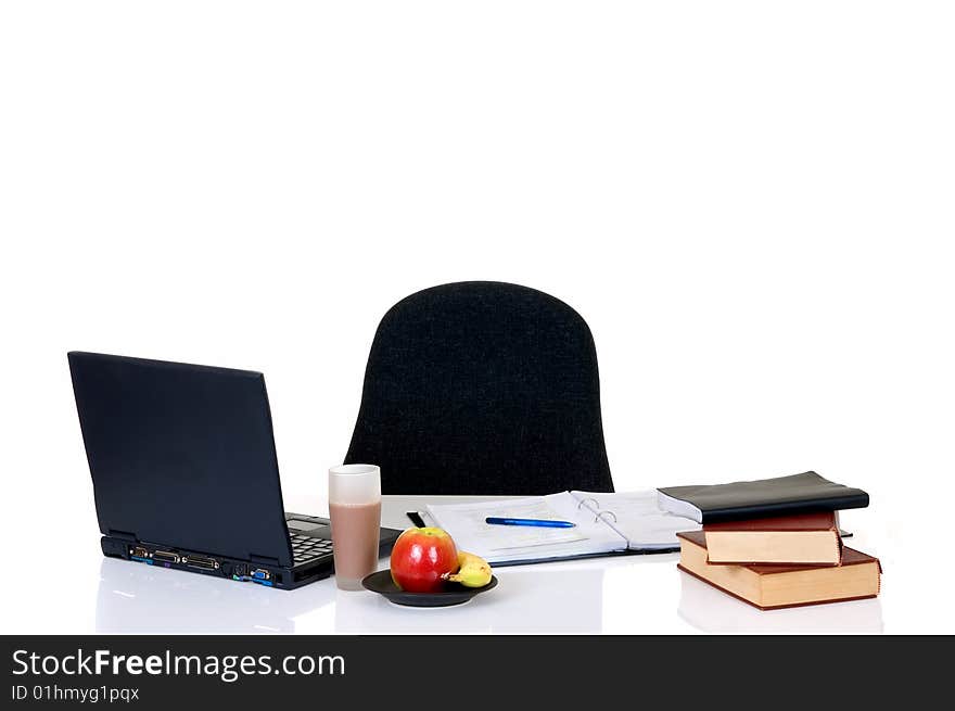 Homework with laptop and books on desk, with background, reflective surface. Homework with laptop and books on desk, with background, reflective surface