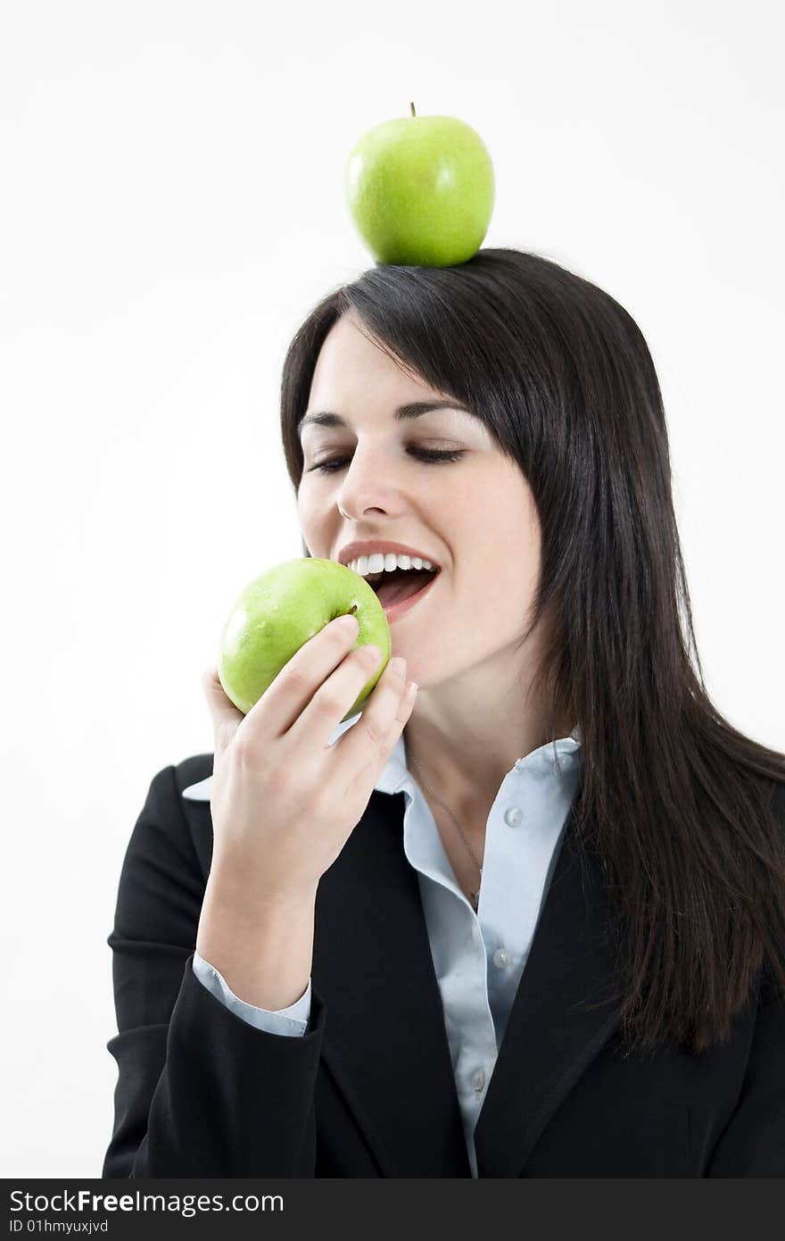 Mid adult woman with green apple on head on white background