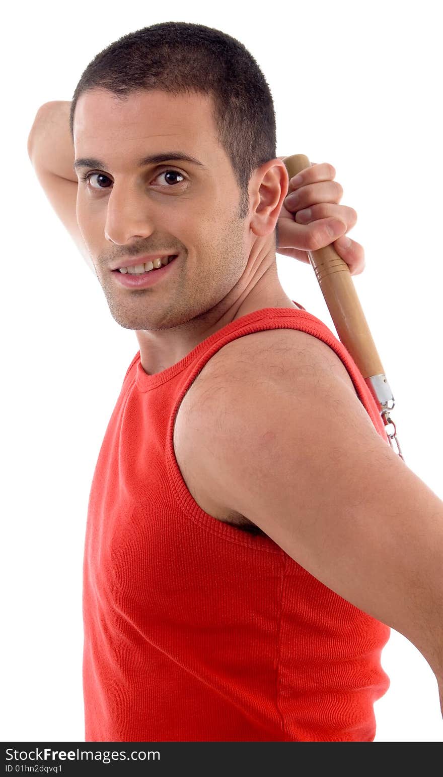 Handsome male with nunchaku against white background