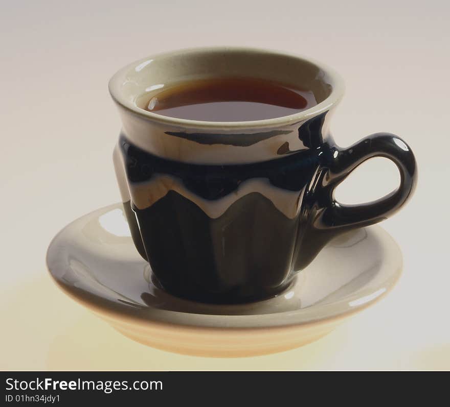 Black cup of tea isolated on a white background