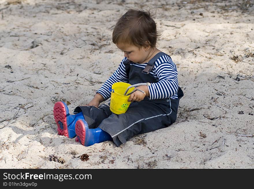 Child  in sailor's striped vest exploring the outside  world. Child  in sailor's striped vest exploring the outside  world