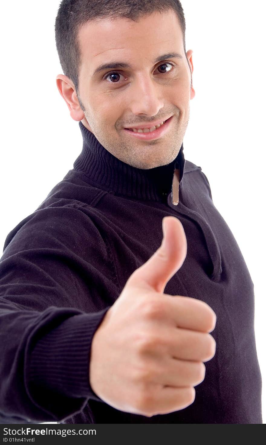 Young man showing thumbs up and looking at camera on an isolated white background