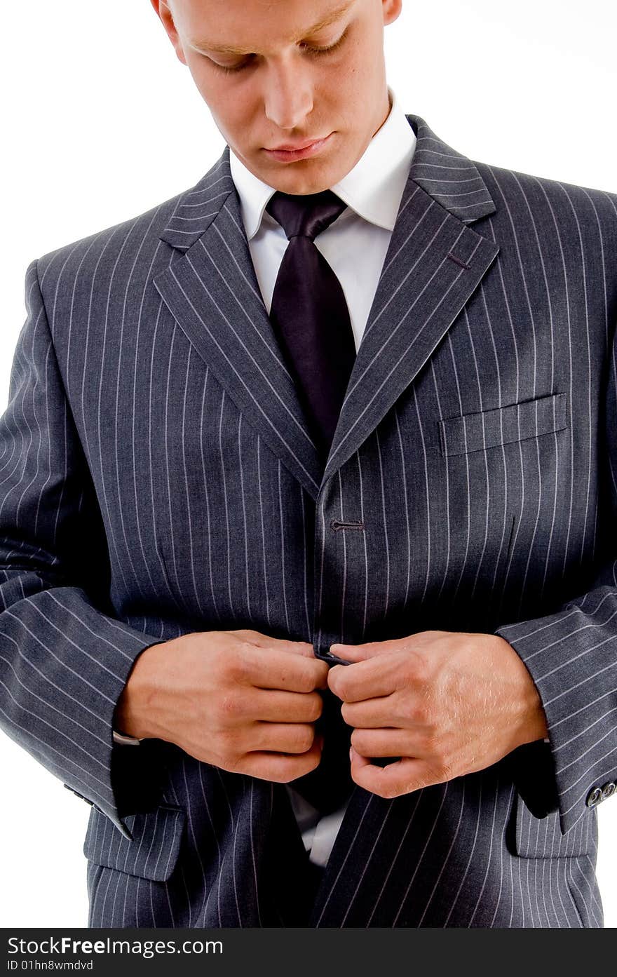 Businessman tucking his coat button with white background