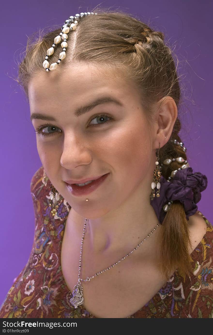 Portrait of nice young girl with plait against violet background. Portrait of nice young girl with plait against violet background