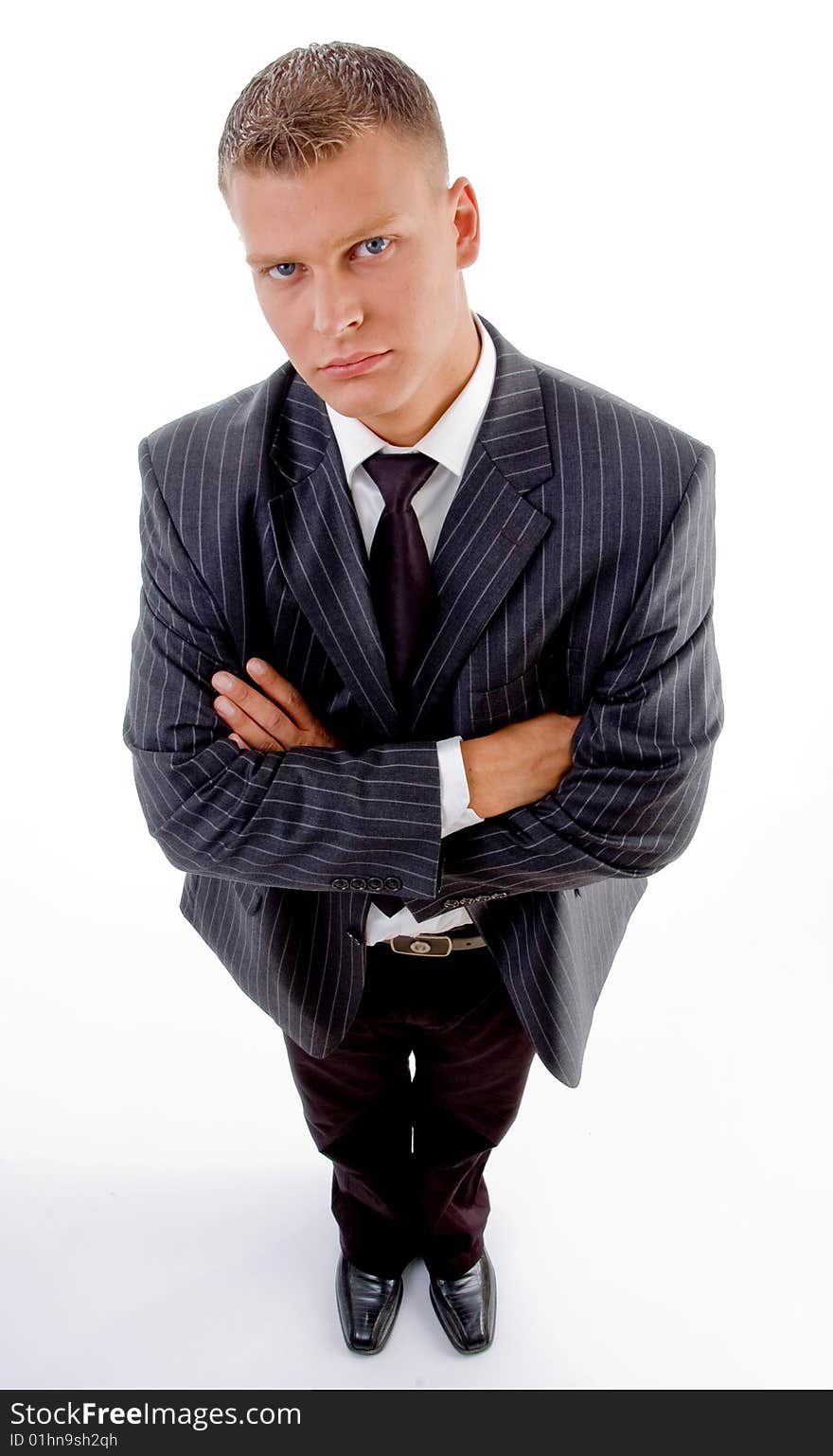 Standing businessman with folded hands on an isolated white background