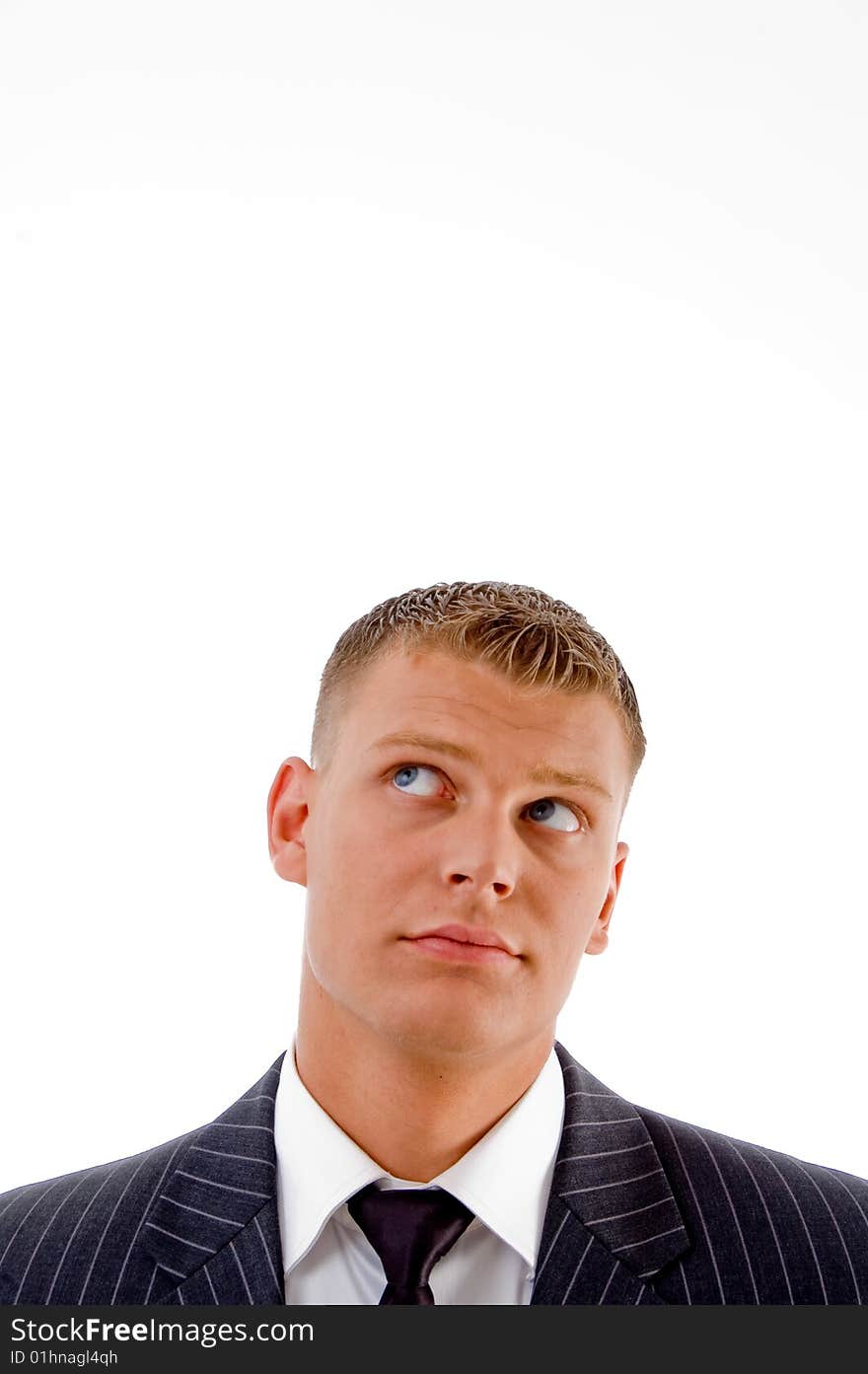 Handsome executive looking upward on an isolated white background