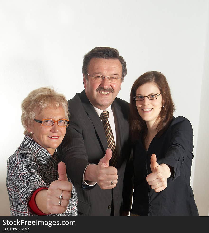 Senior business team with a young female worker giving thumbs up sign!. Senior business team with a young female worker giving thumbs up sign!