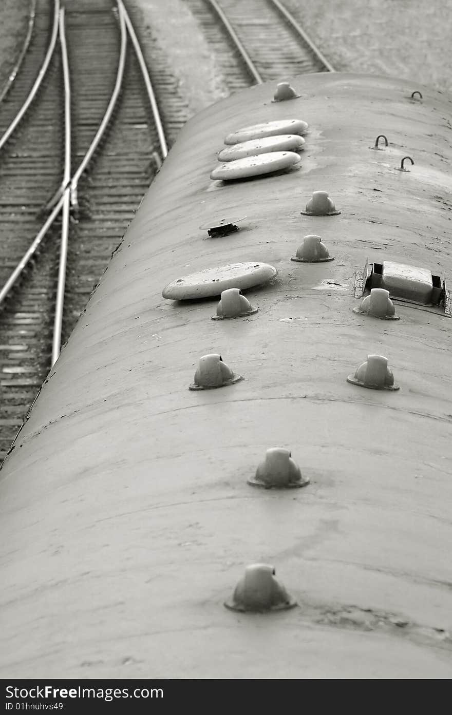 Vintage train carriage with tracks curving into the distance