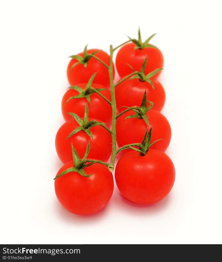 Eight cherry tomatoes on branch