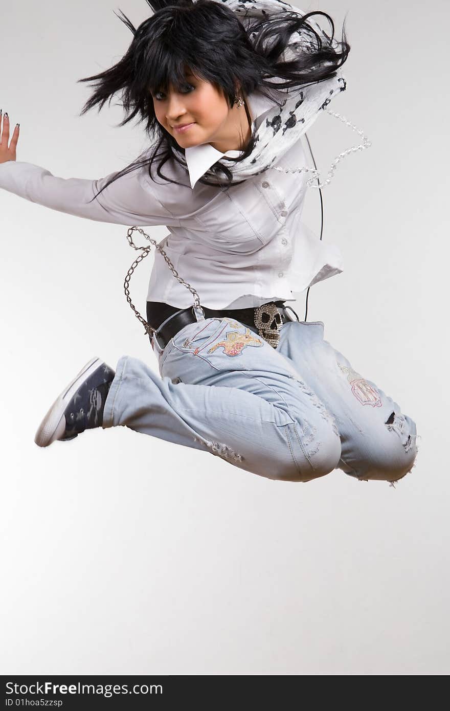 Attractive brunette jumping with headphones. Attractive brunette jumping with headphones