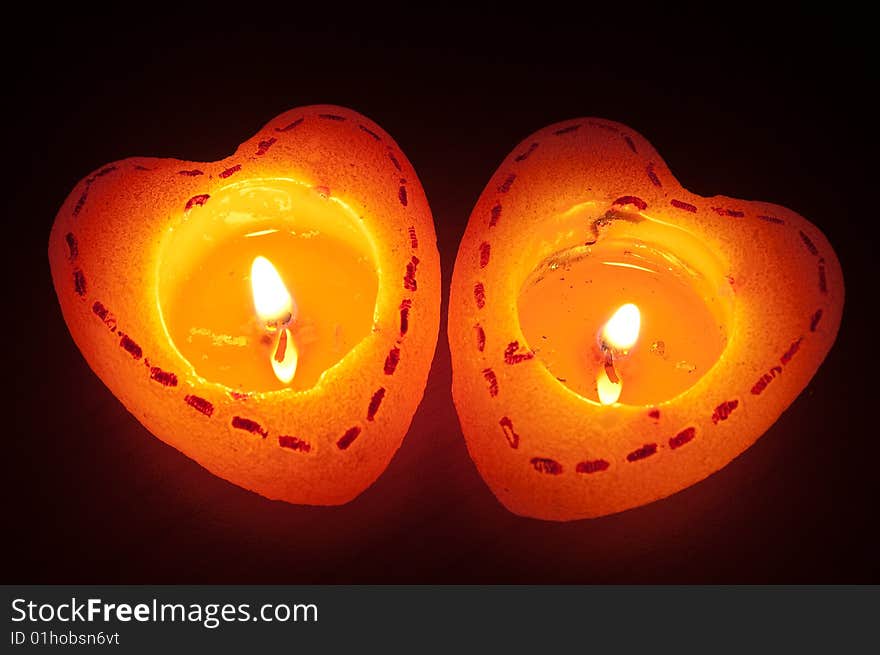 Two burning heart candles