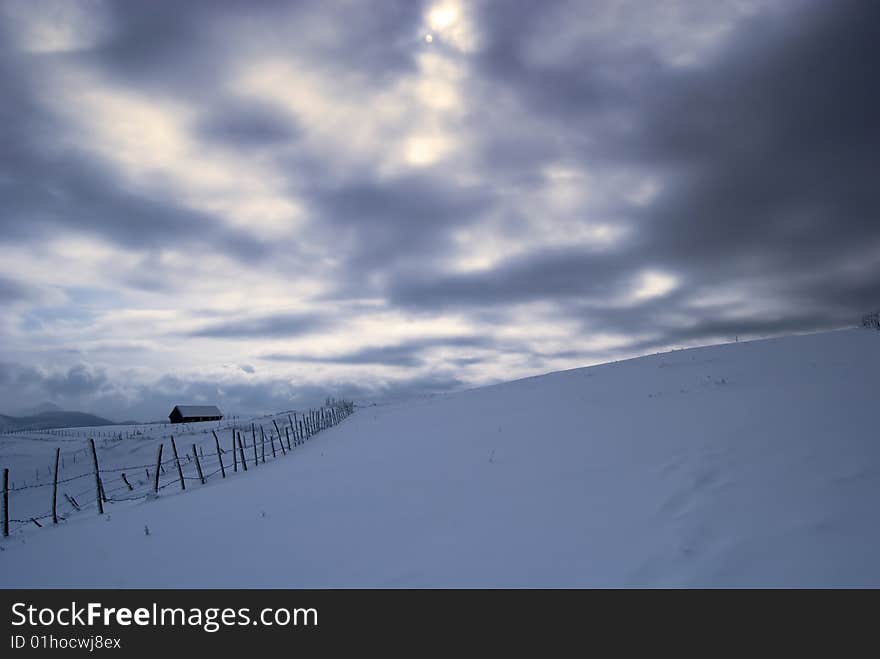 Winter landscape;Lonley house in a village in the mountains,in Romania. Winter landscape;Lonley house in a village in the mountains,in Romania