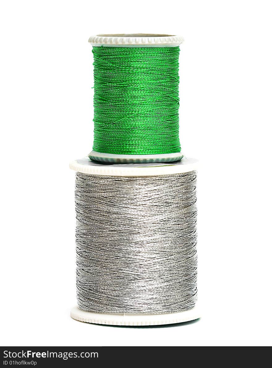 Green and silver spools of threads