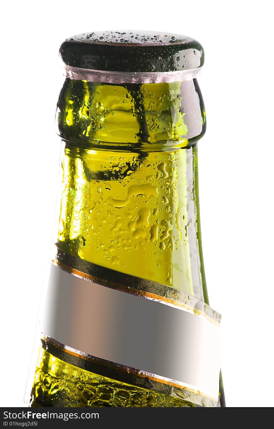 Yellow bottle of beer with water drops