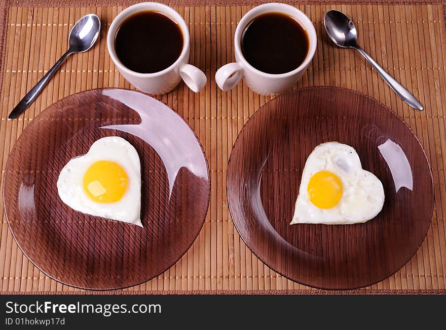 Fried eggs and two cups of black coffee. Fried eggs and two cups of black coffee