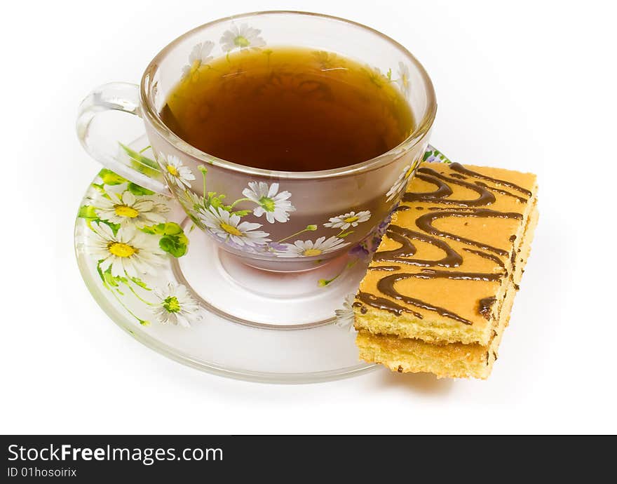 Cap of tea on saucer with cake on white