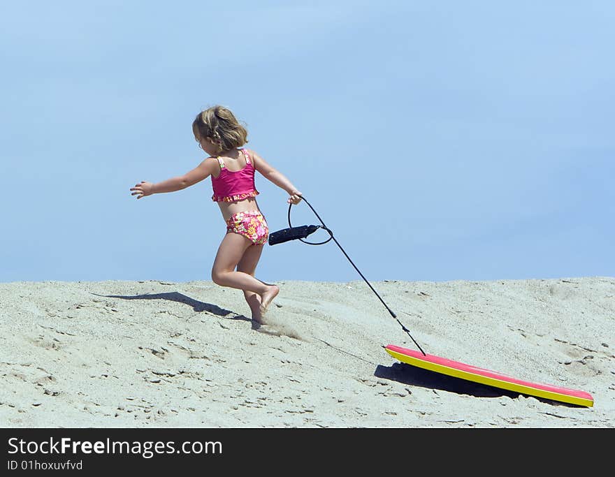 Child running up sand dune