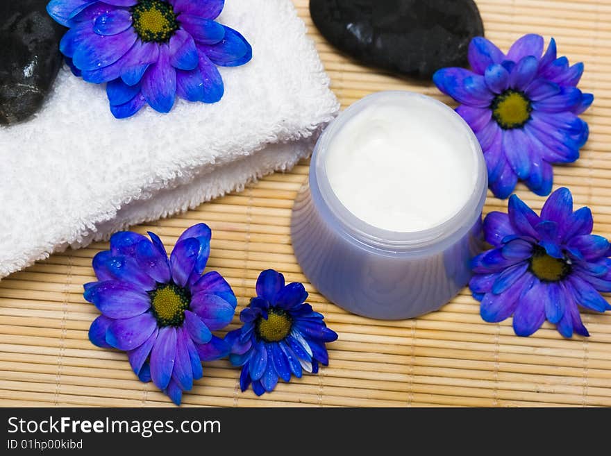 Cream, stones and towel with flowers