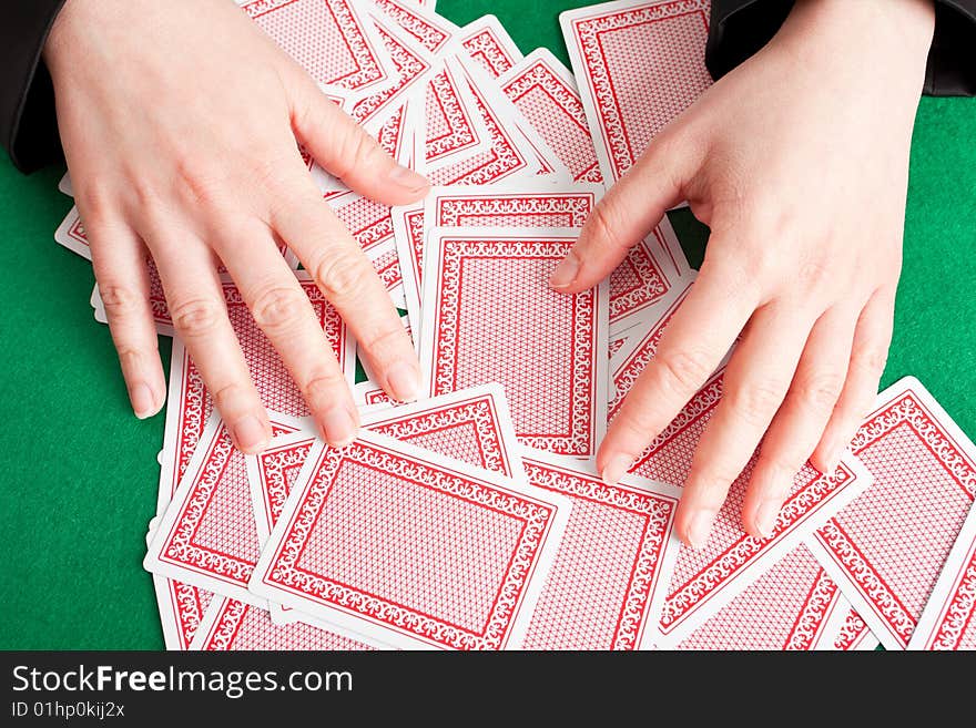 Croupier mixing playing cards on a  table. Croupier mixing playing cards on a  table