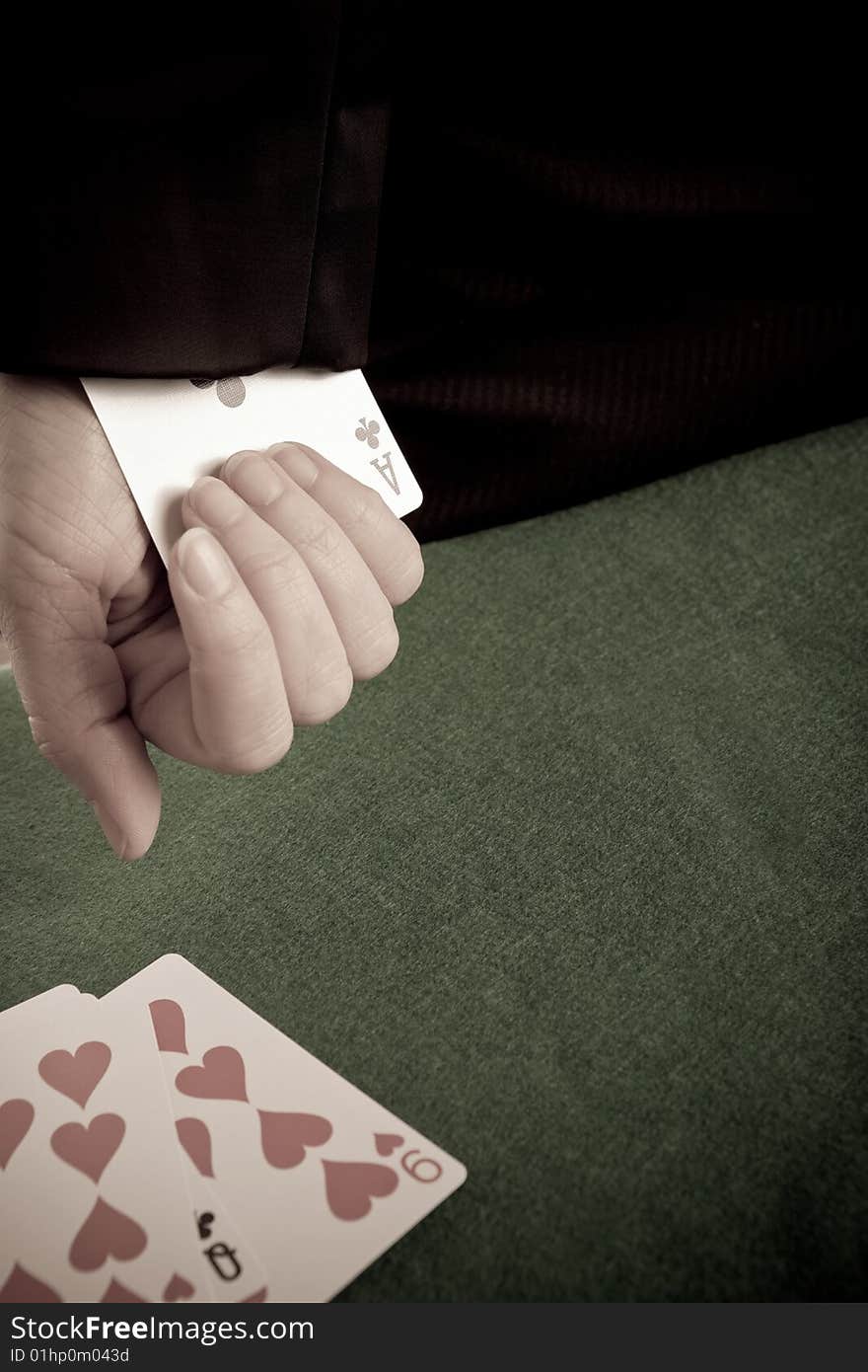 Woman with a playing card up her sleeve and cards on the table. Woman with a playing card up her sleeve and cards on the table