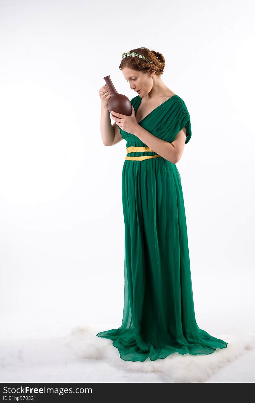 Lady in green antique dress handing jug on white background. Lady in green antique dress handing jug on white background