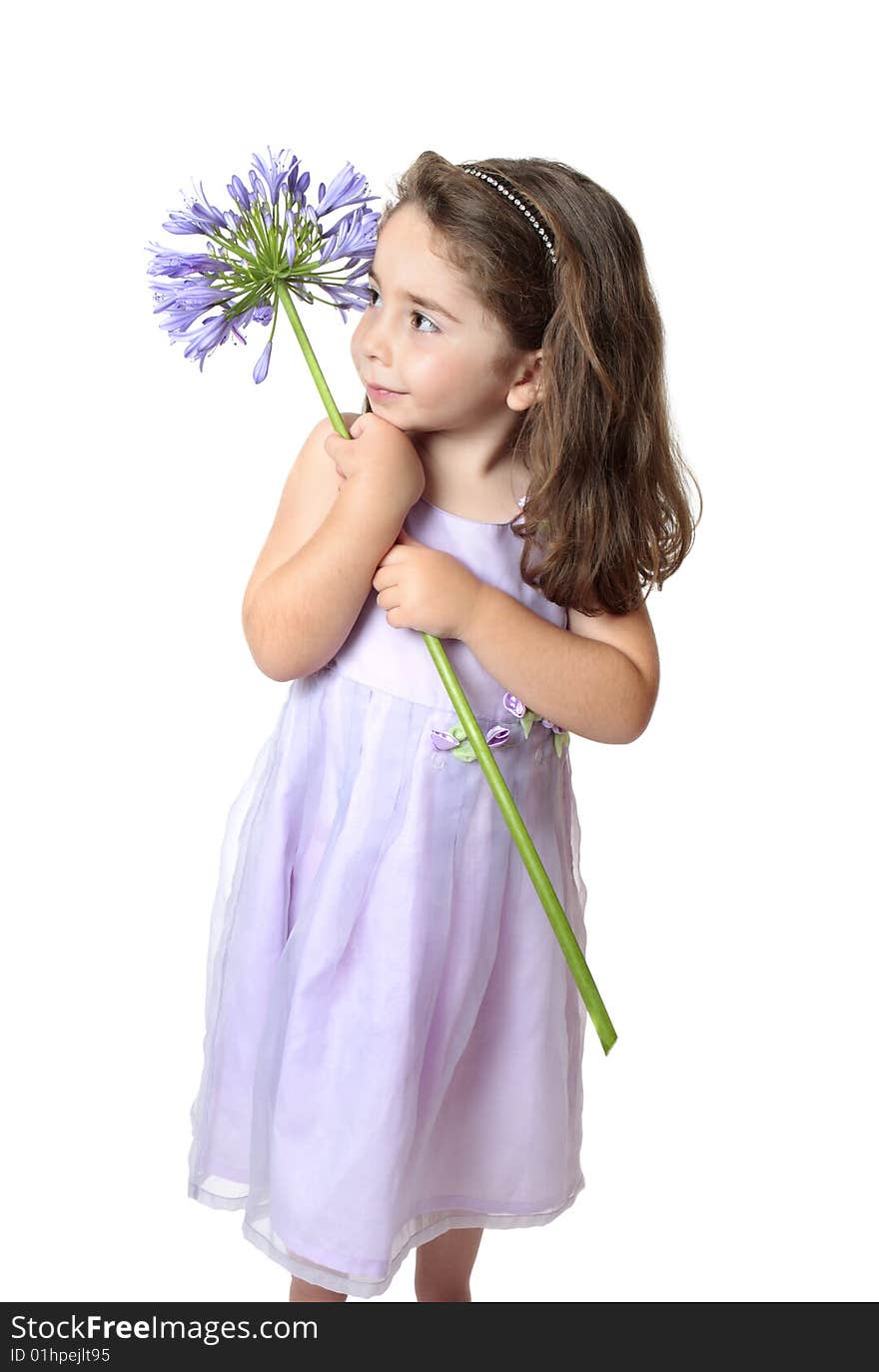 Pretty young girl in a dress holding a large purple agapanthus. Pretty young girl in a dress holding a large purple agapanthus.