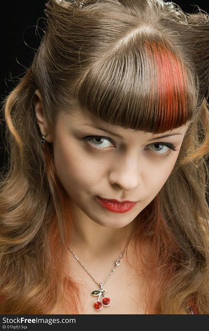 Beautiful woman looking coquettishly at camera over dark background