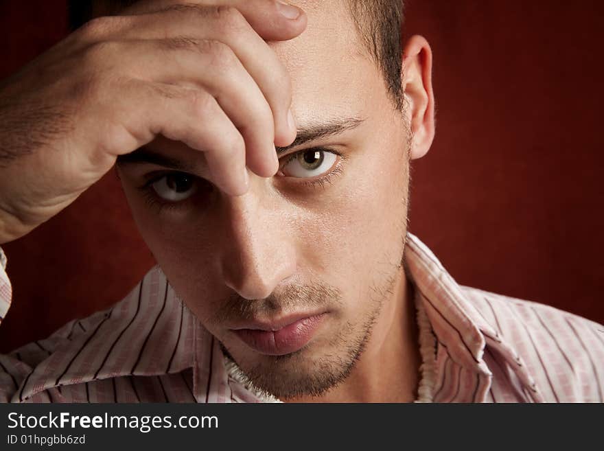 Young man with stubble in serious thought. Young man with stubble in serious thought