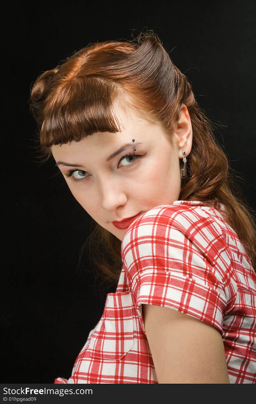 Beautiful retro woman looking coquettishly at camera over her left shoulder