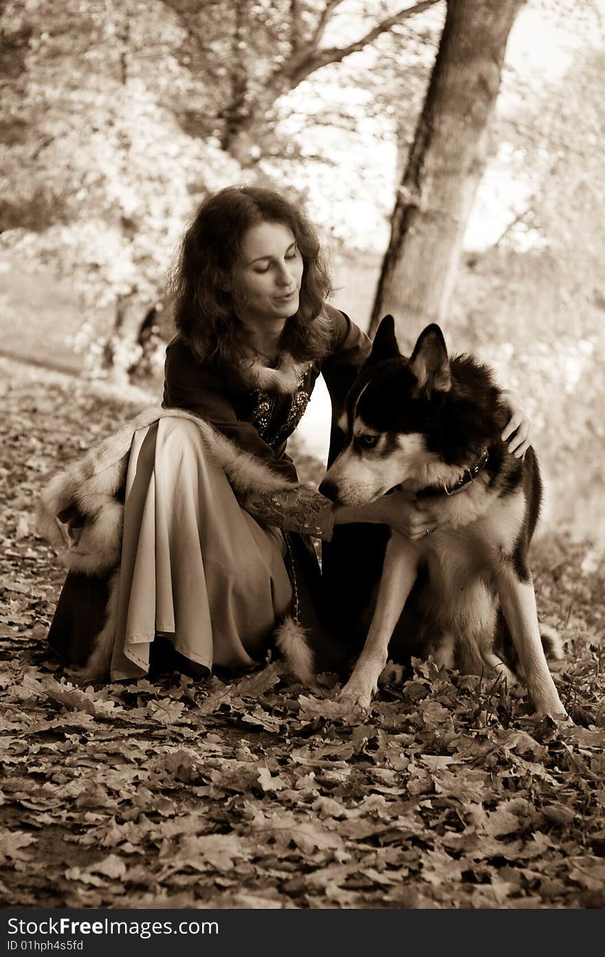 Lady in medieval dress and dog in the forest. Lady in medieval dress and dog in the forest