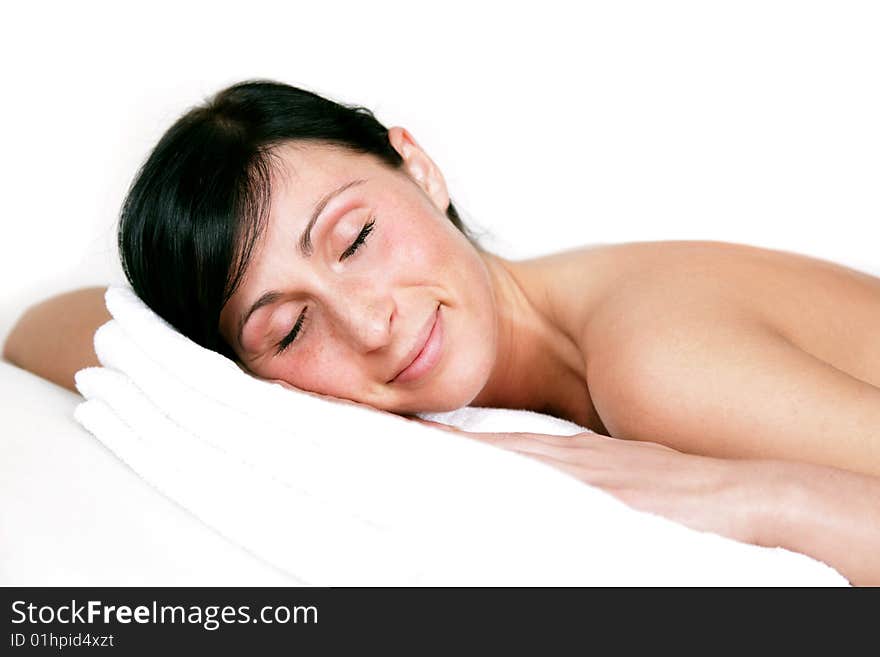 Relaxing spa girl lying on towel with closed eyes. Relaxing spa girl lying on towel with closed eyes