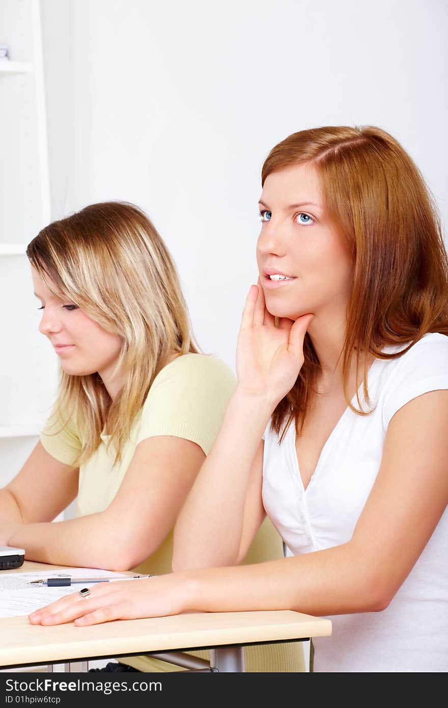 Two students thinking sitting at school desk. Two students thinking sitting at school desk