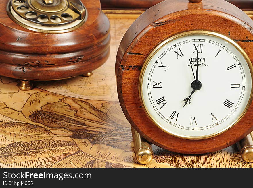 Old-fashion objects as background: wooden clock and telephone