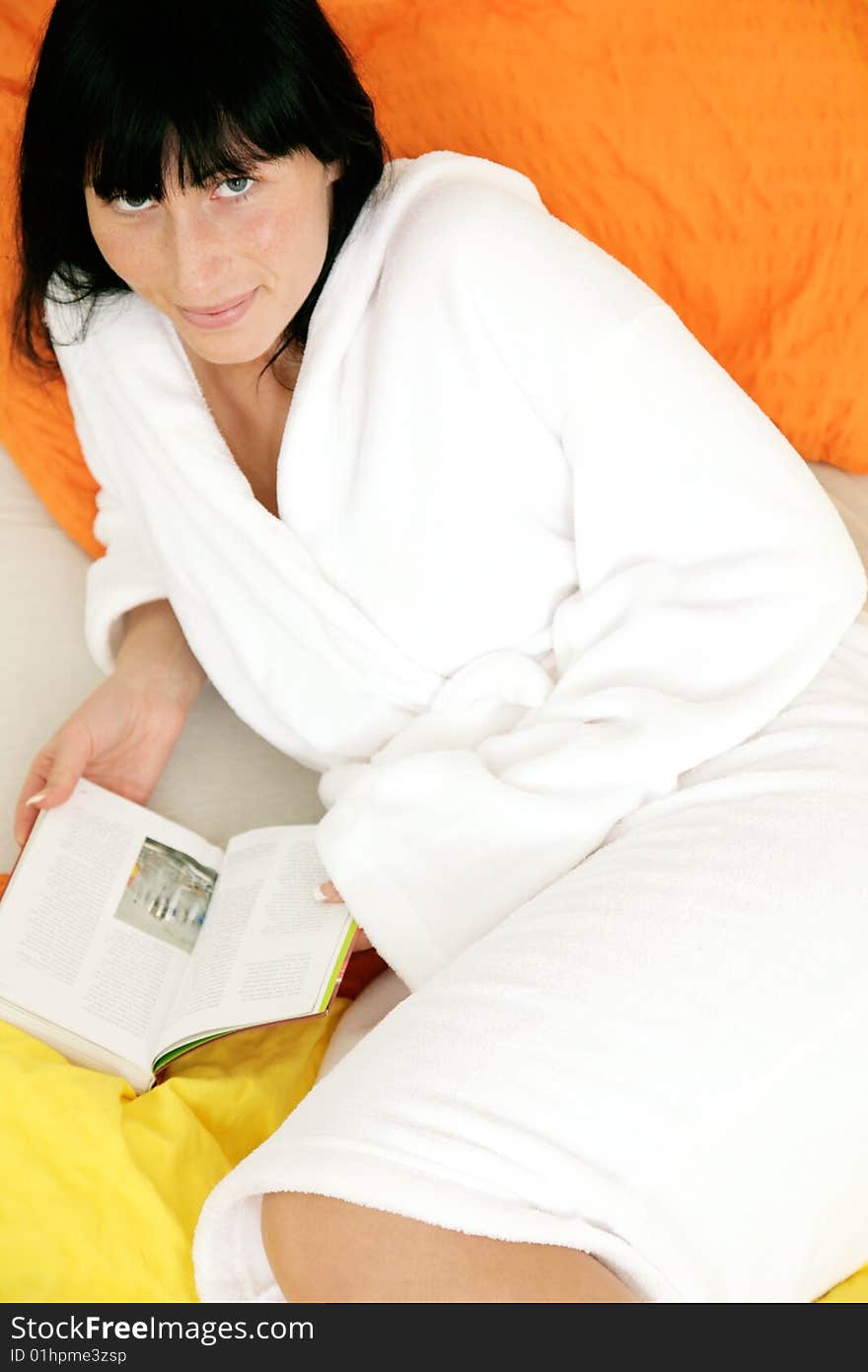 Woman in bathroom whlie reading book in bed. Woman in bathroom whlie reading book in bed