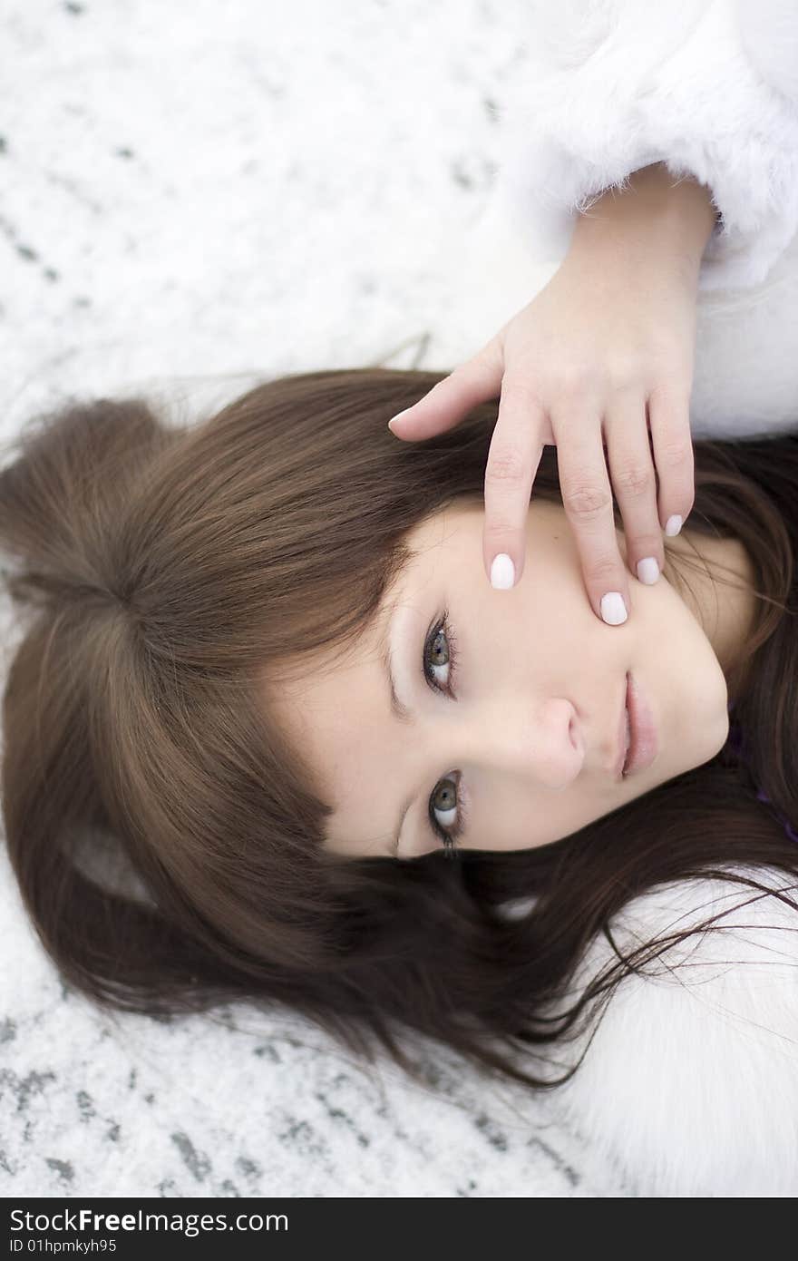 Picture of a girl who lies on the snow in the purple dress. Picture of a girl who lies on the snow in the purple dress