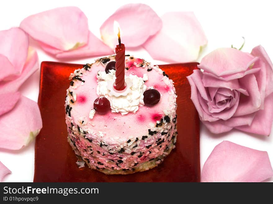 Cake with candle and pink rose