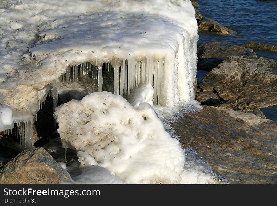 Icicles on the rocks on waterfront