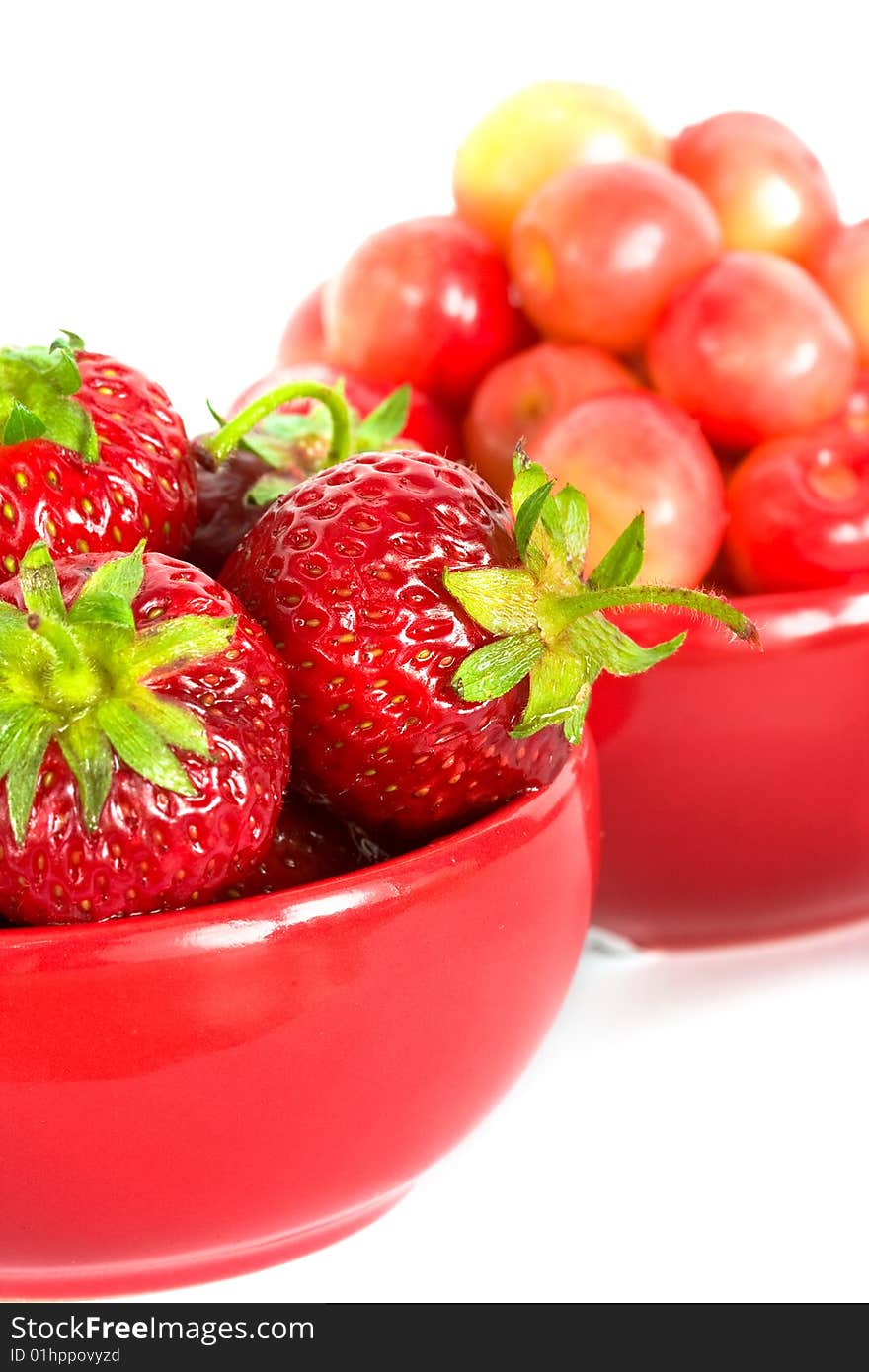 Strawberry and cherry on red plates