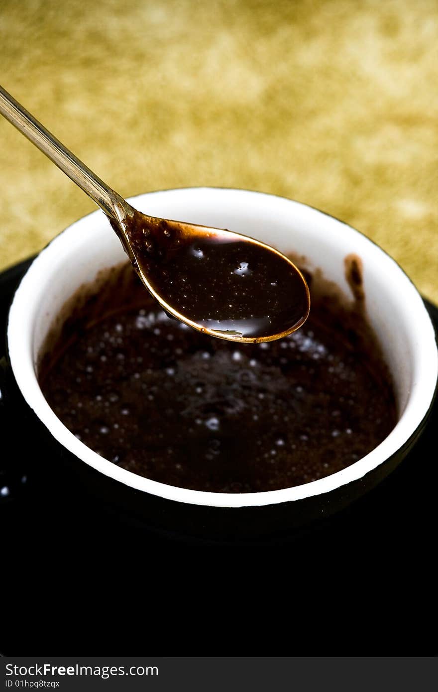 Black cup of chocolate with spoon