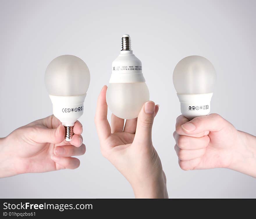 Energy saving lamps in human hands