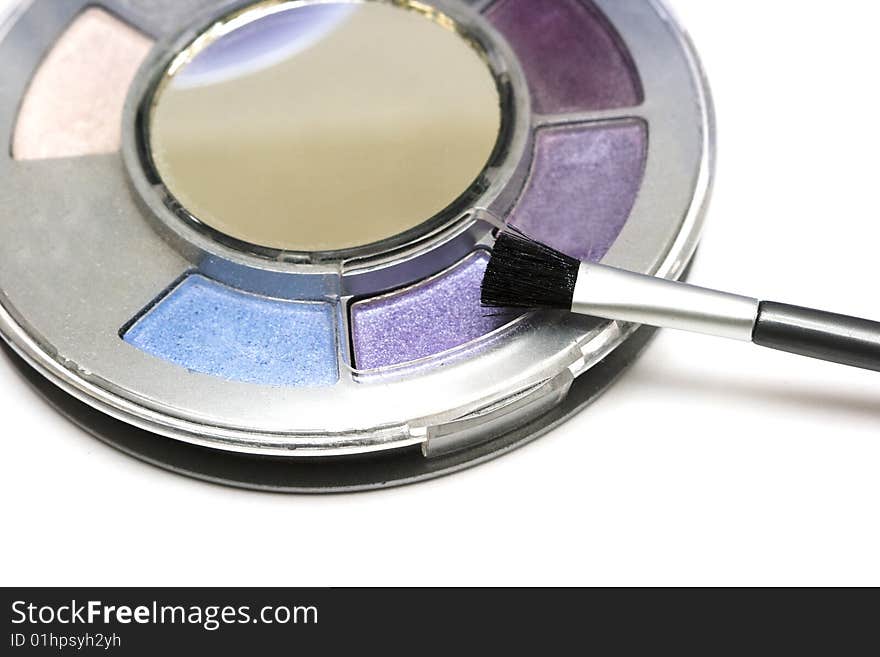 Violet make-up eyeshadows and cosmetic brush