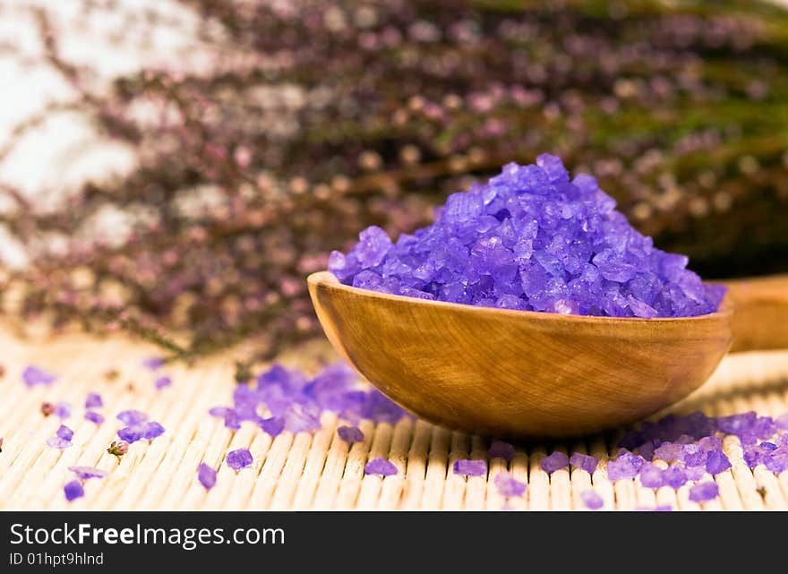 Spa essentials (bath salt in a spoon and flowers of lavender)