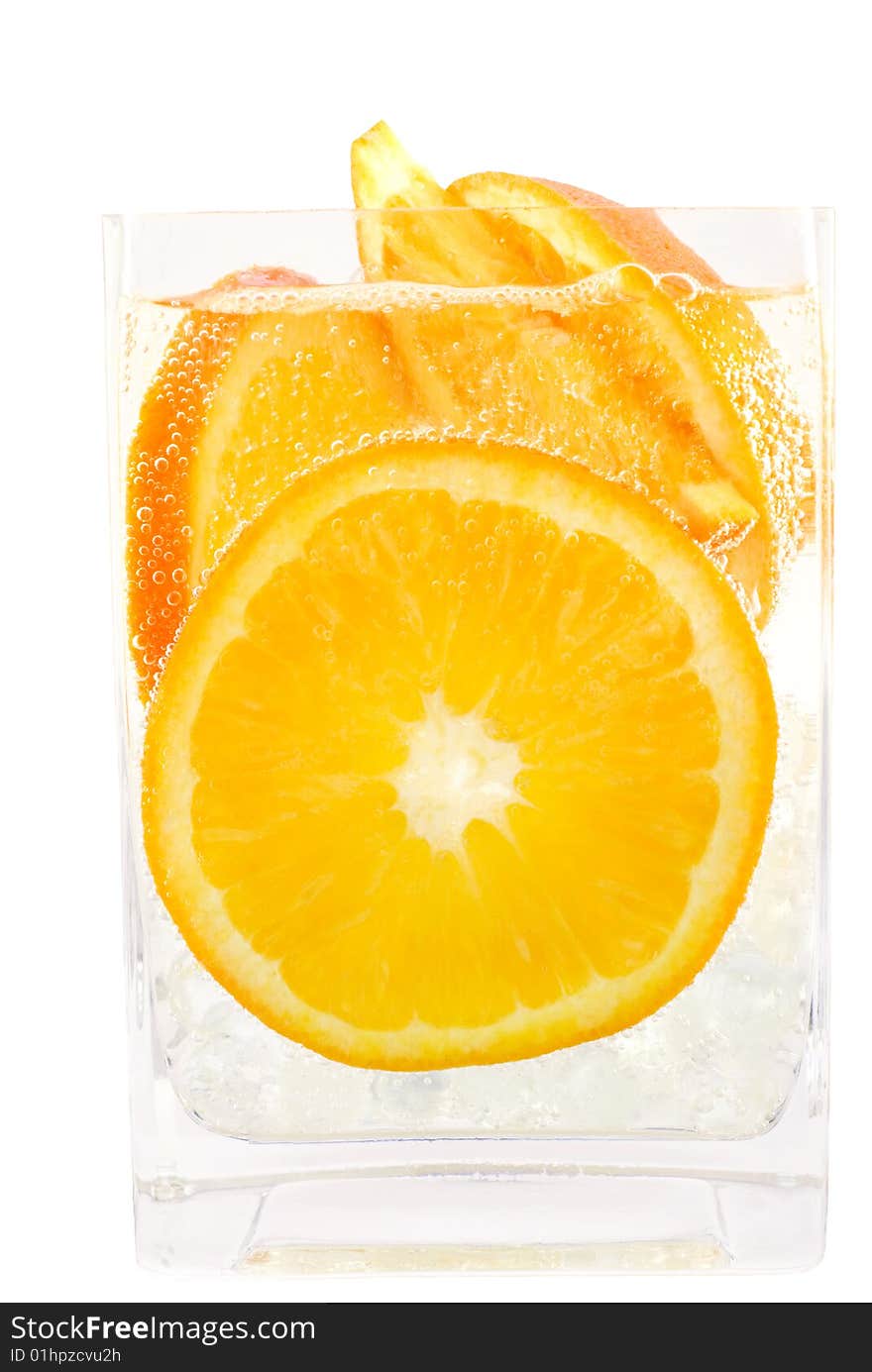 Refreshing carbonated soda poured over fresh orange slices for a refreshing drink copy space. Refreshing carbonated soda poured over fresh orange slices for a refreshing drink copy space